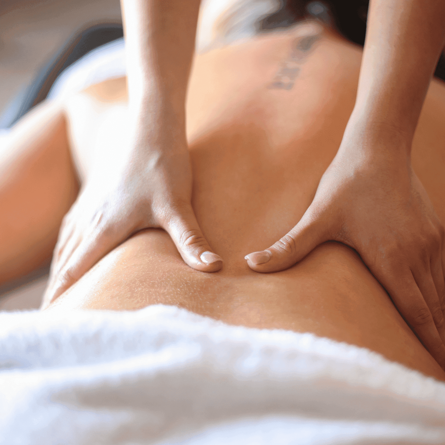 Person receiving a back massage with professional hands focusing on relaxation and therapy.